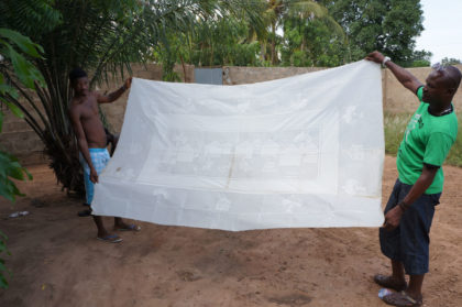 Dépot de cire sur une grande nappe avant un bain de couleur