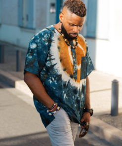 Haut de boubou africain homme en calicot teinté porté avec un collier et des bracelets en perles