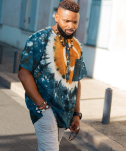 Haut de boubou africain homme en calicot teinté porté avec un collier et des bracelets en perles